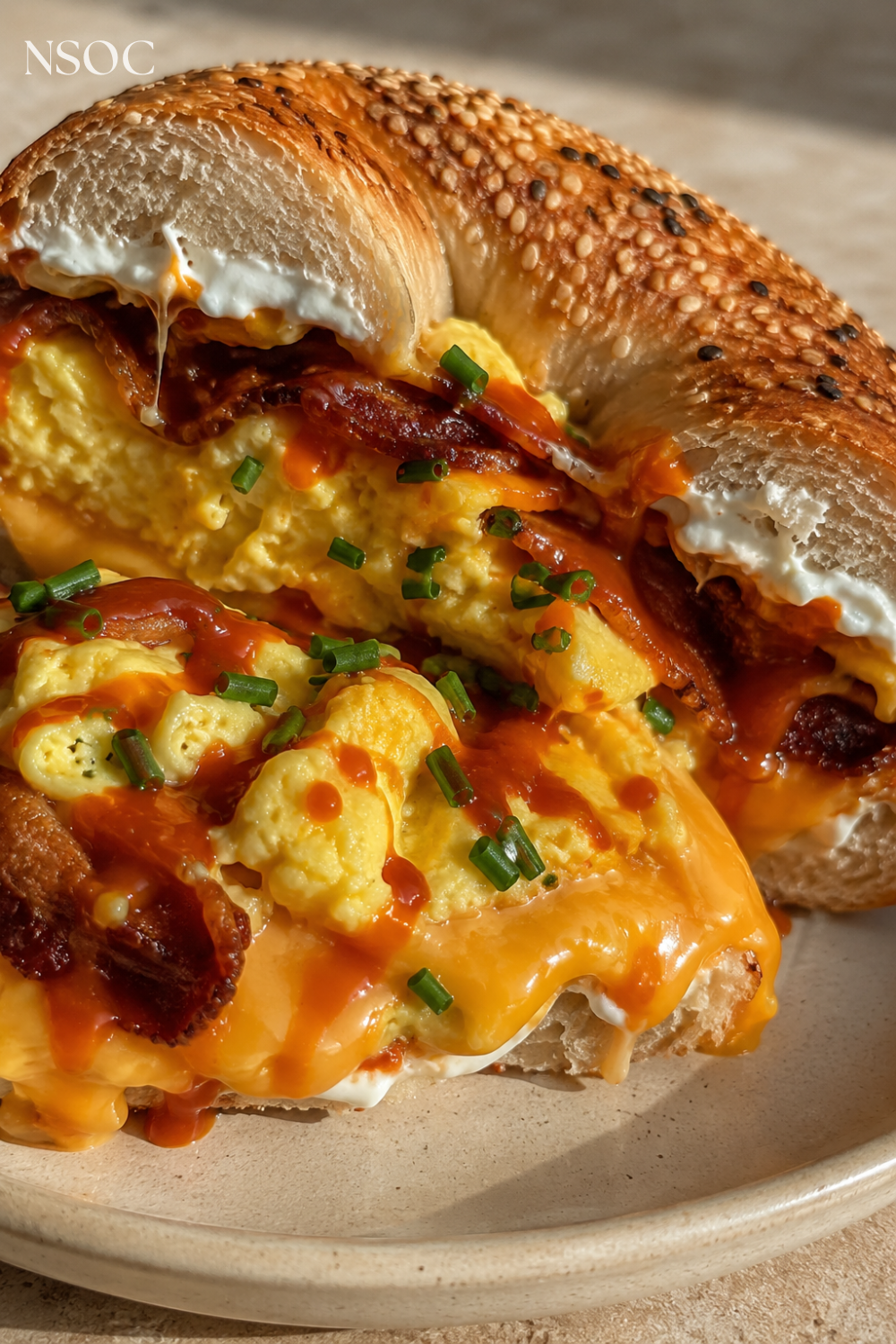 Vertical Pinterest pin of a bacon, egg and cheese bagel sandwich