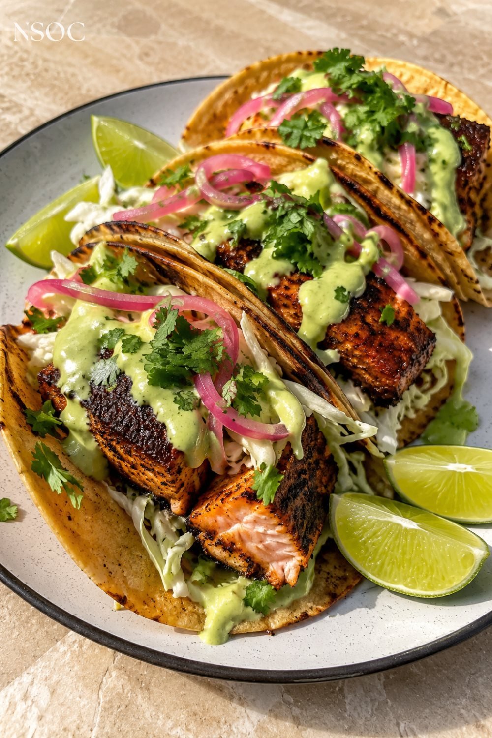 Vertical Pinterest pin of blackened salmon tacos with lime, an example of NSOC campaign food photography