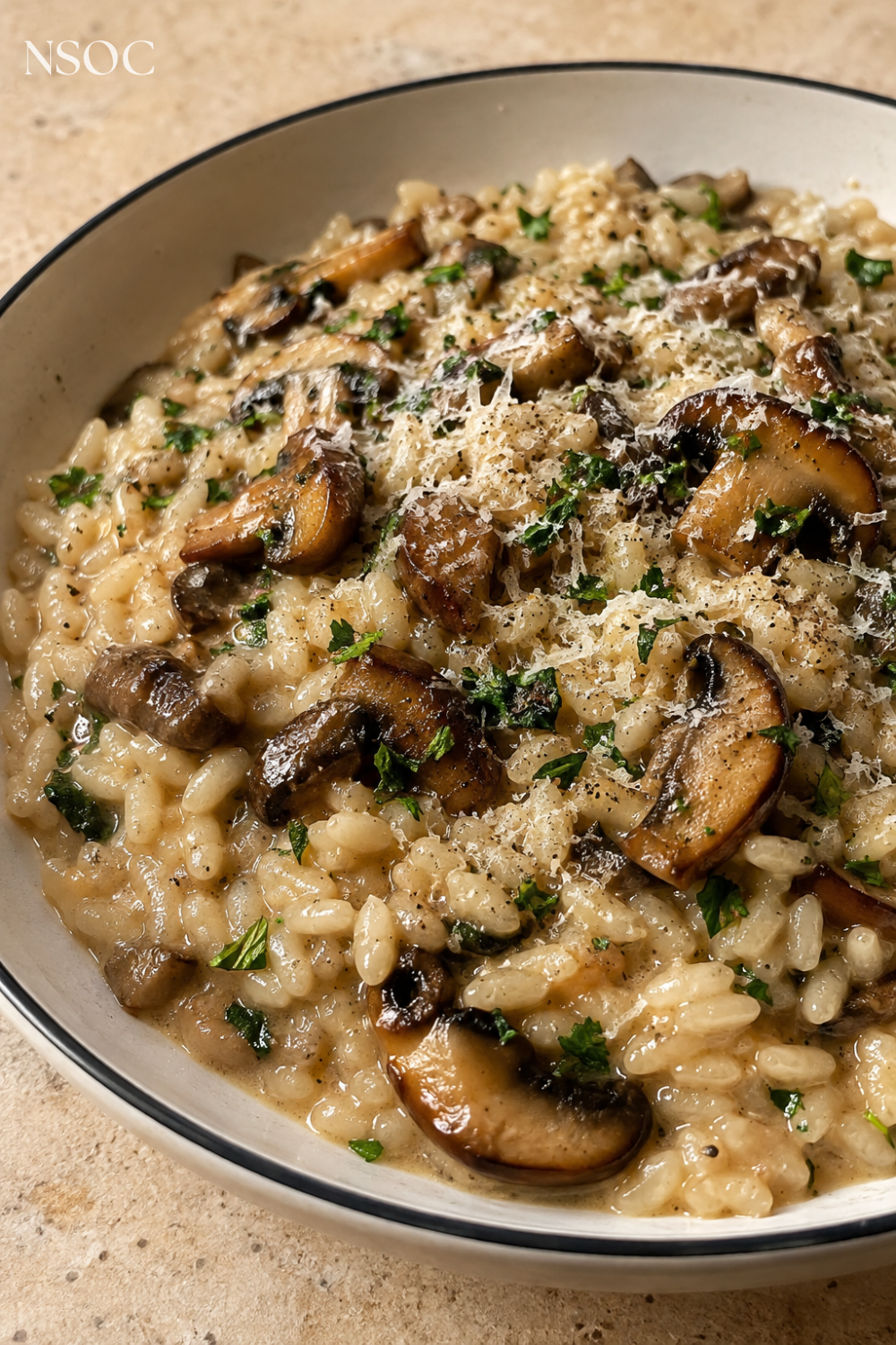 Vertical Pinterest pin of creamy mushroom risotto finished with olive oil