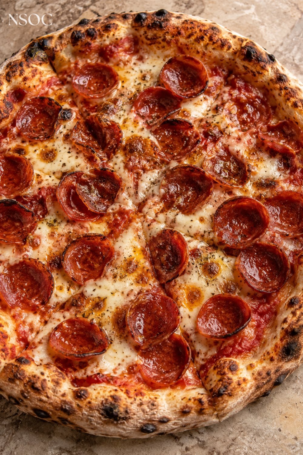 Vertical Pinterest pin of a cheesy pepperoni pizza