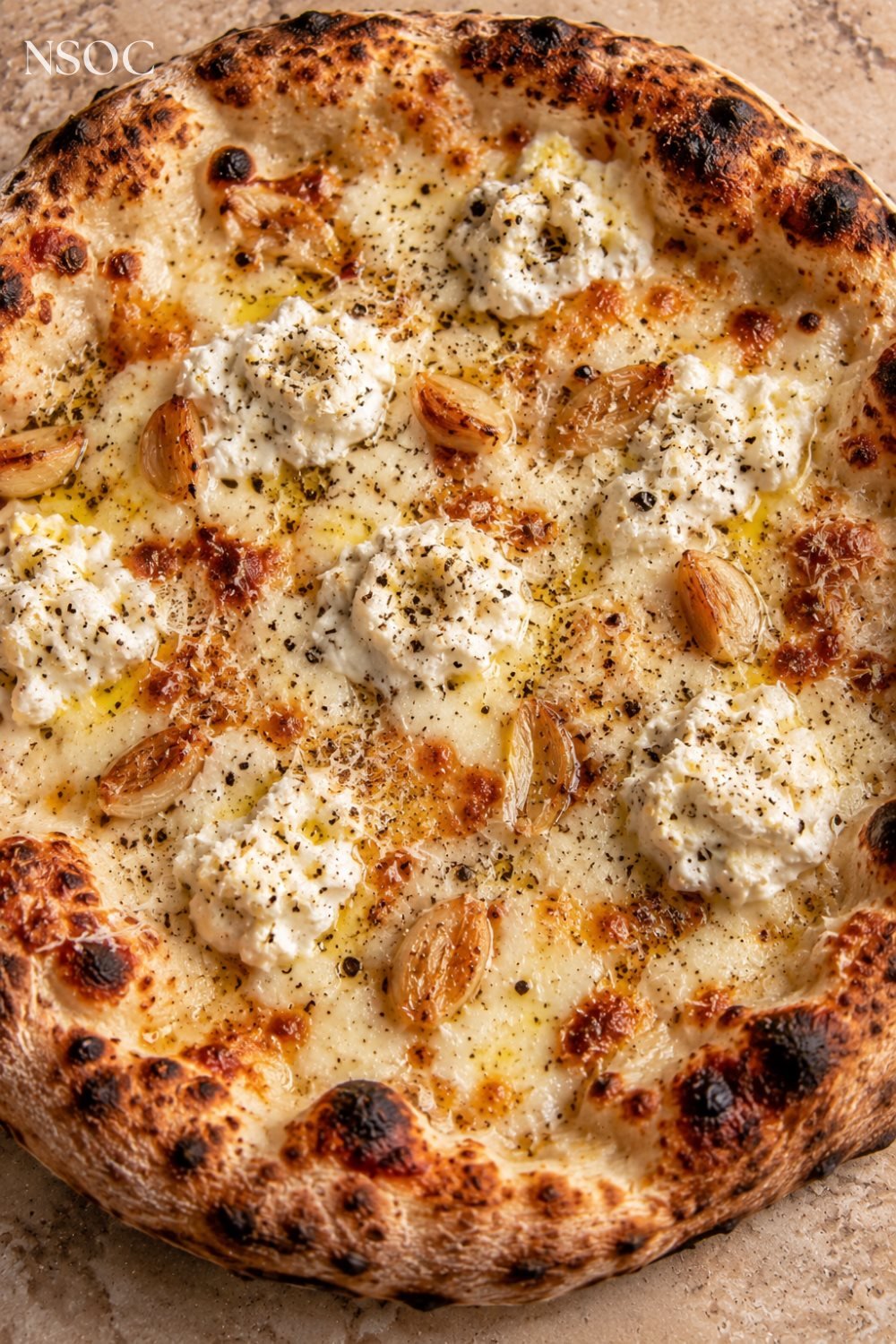 Vertical Pinterest pin of a white pizza with ricotta and garlic