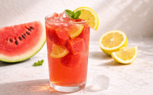 Mint Green Iced Tea fresh watermelon lemonade with ice, lemon slices, and watermelon cubes