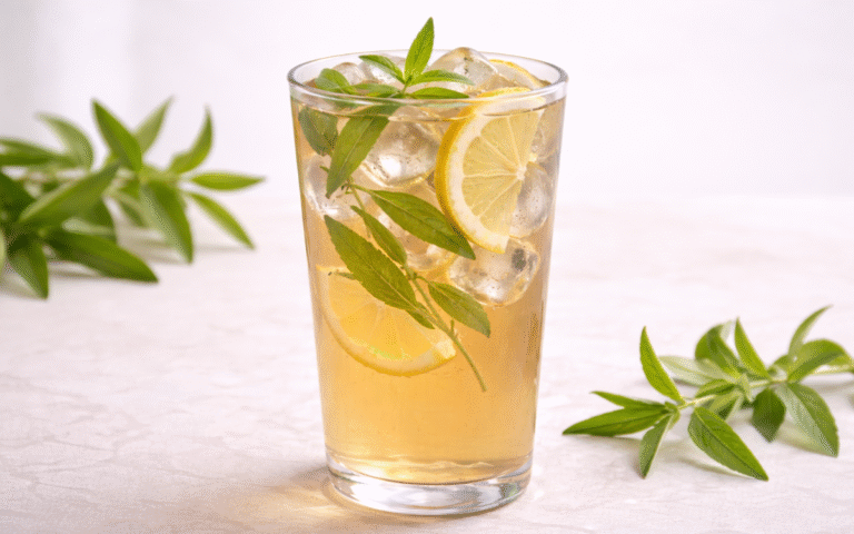 light lemon verbena iced tea with lemon slices and fresh herbs in glass