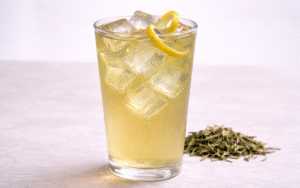 cold brew green tea served over ice with lemon peel twists