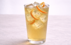 grapefruit green iced tea served over ice with grapefruit peel twists
