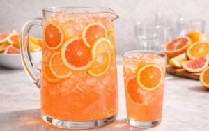 grapefruit orange pitcher drink with ice and citrus slices