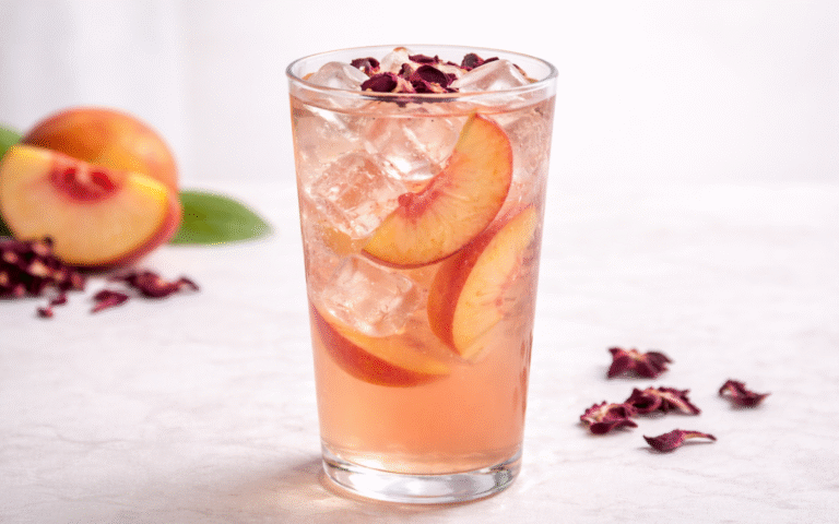 hibiscus peach white iced tea served over ice with peach slices