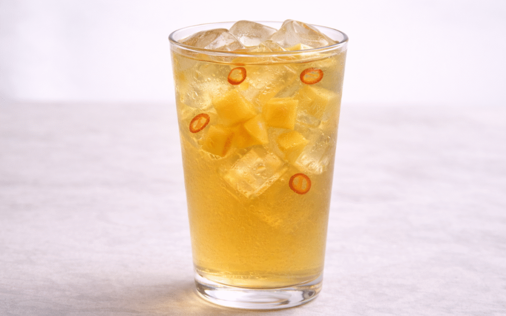 Mango Iced Green Tea mango iced green tea served over ice with fresh mango cubes and deseeded chili slices