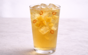 mango iced green tea served over ice with fresh mango cubes and deseeded chili slices