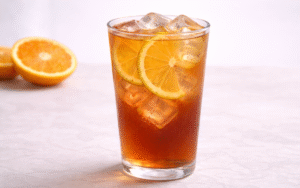 orange cold brew iced tea served over ice with fresh orange slices