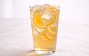 orange jasmine iced tea served over ice with orange peel twist
