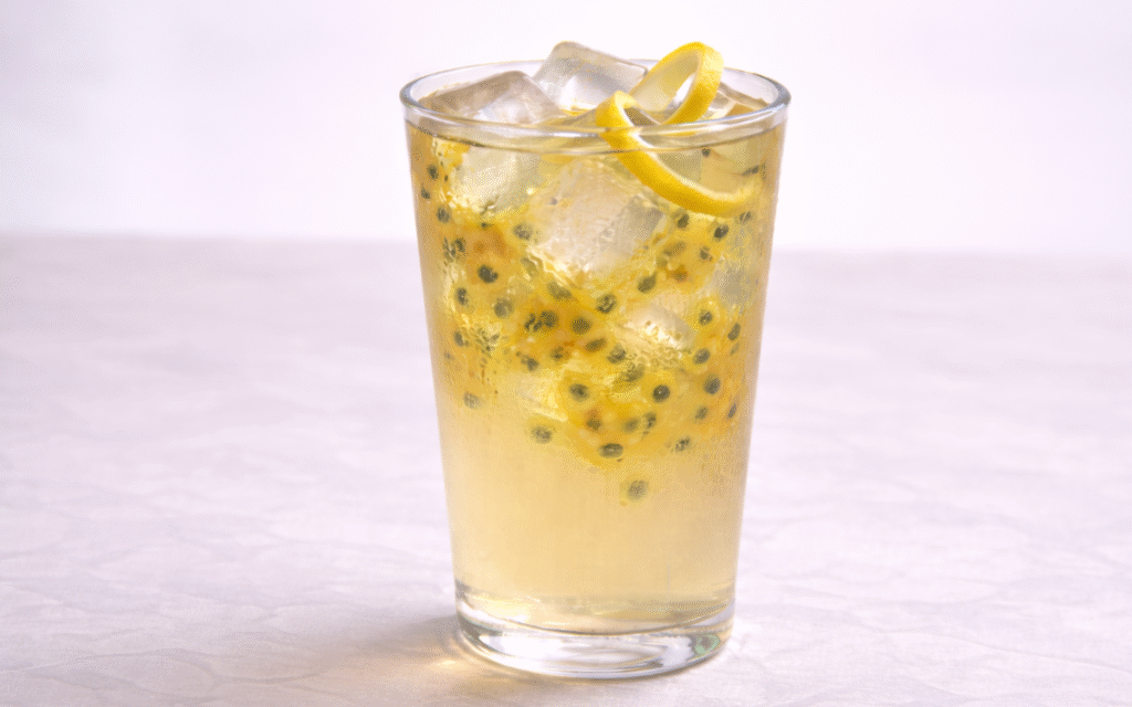 passion fruit white iced tea served over ice with visible passion fruit pulp