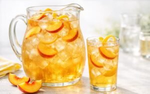 peach iced tea pitcher with fresh peach slices and ice