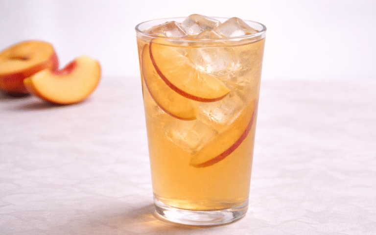 peach jasmine iced tea served over ice with fresh peach slices