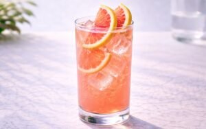 pink grapefruit lemonade with ice and citrus slices