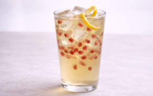 pomegranate iced green tea served over ice with fresh pomegranate arils