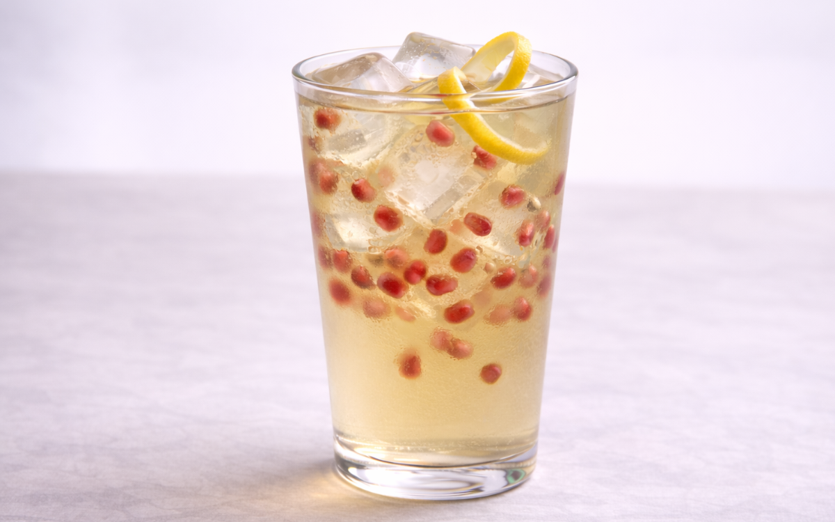 pomegranate iced green tea served over ice with fresh pomegranate arils