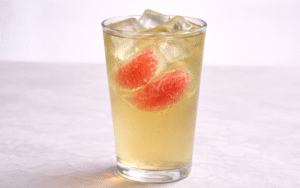 pomelo green iced tea served over ice with fresh pomelo segments