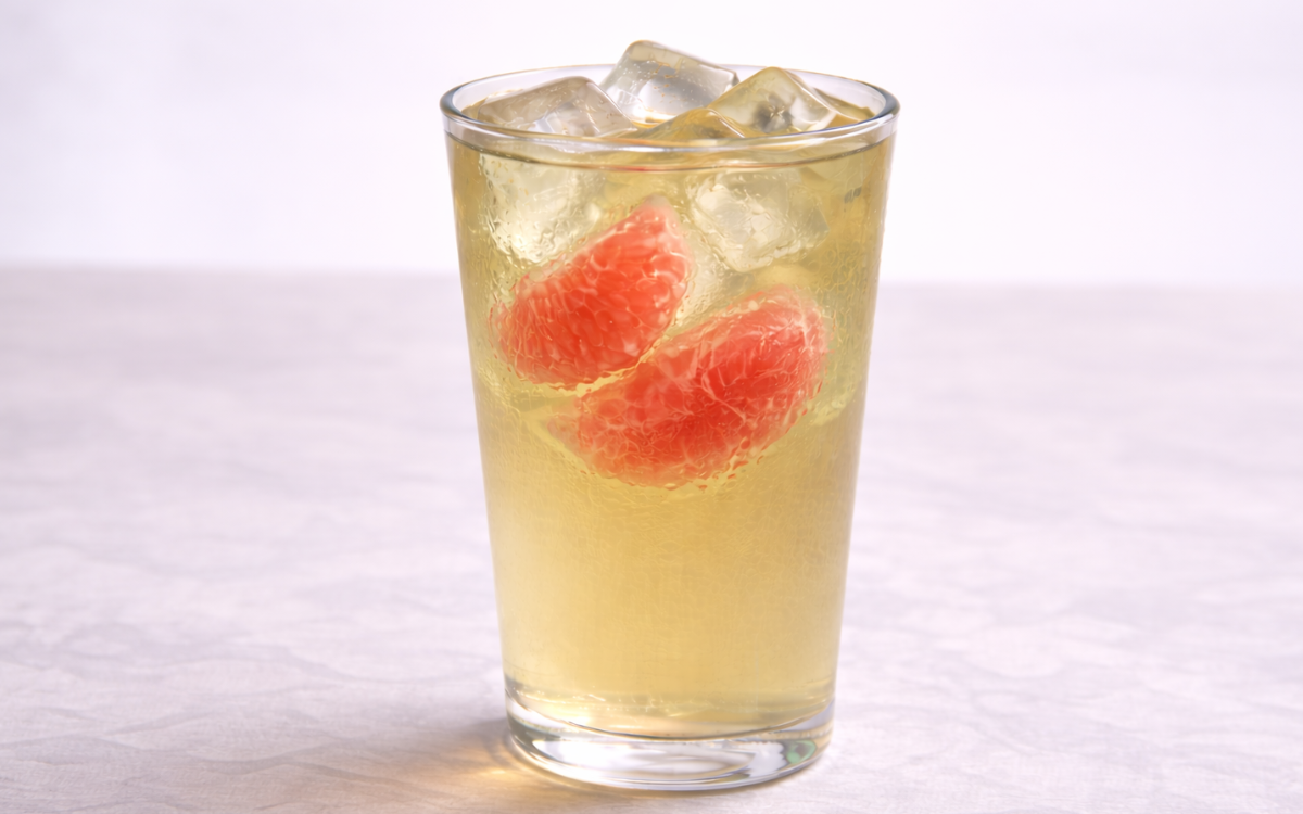 pomelo green iced tea served over ice with fresh pomelo segments