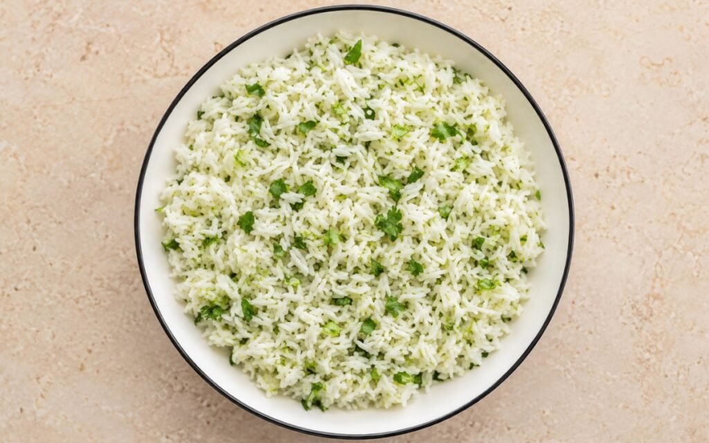 White bowl filled with fluffy jasmine rice mixed with bright green cilantro and lime juice