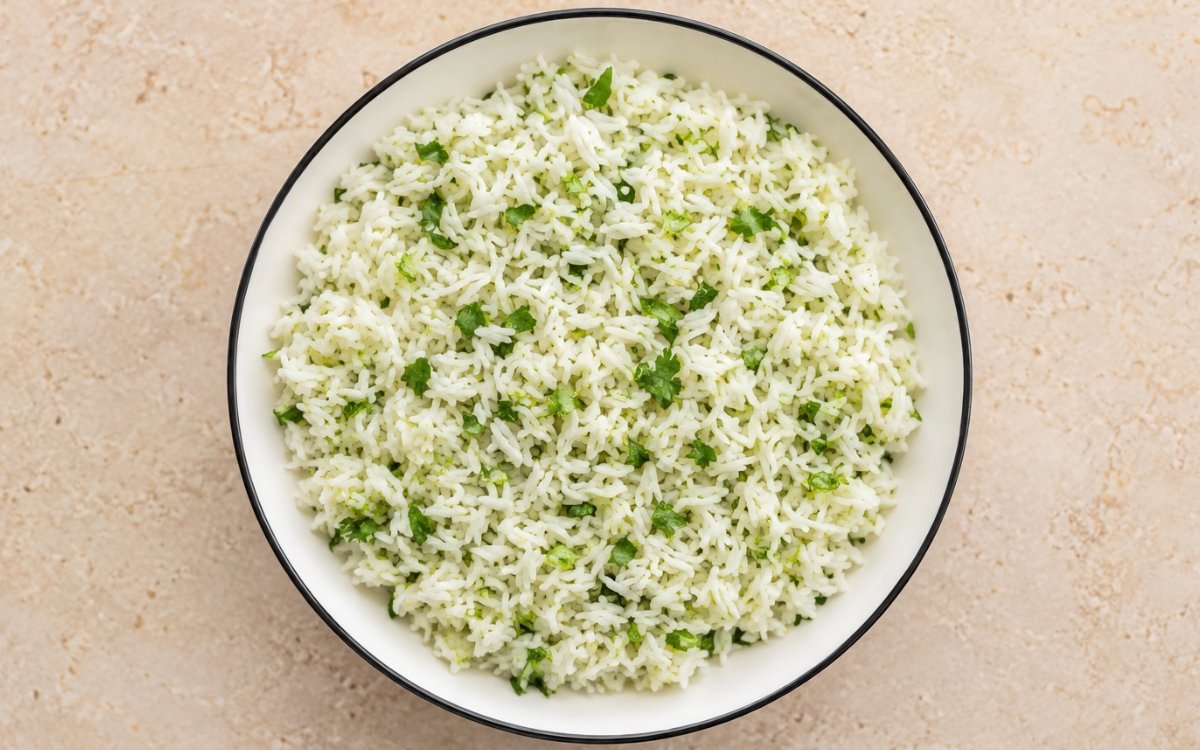 White bowl filled with fluffy jasmine rice mixed with bright green cilantro and lime juice