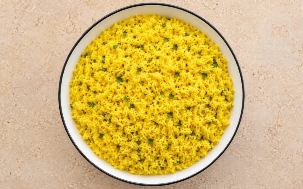 Garlic turmeric yellow rice golden and fluffy garnished with fresh parsley
