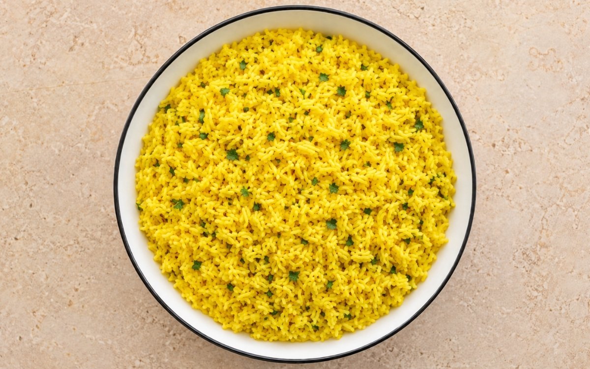 Garlic turmeric yellow rice golden and fluffy garnished with fresh parsley