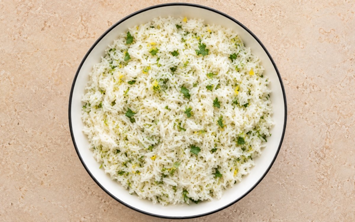Greek lemon rice fluffy and garnished with fresh herbs and lemon zest