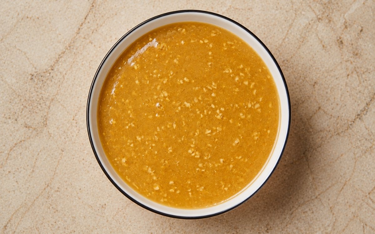 Miso butter sauce in a small white bowl showing golden, glossy sauce with visible miso swirls
