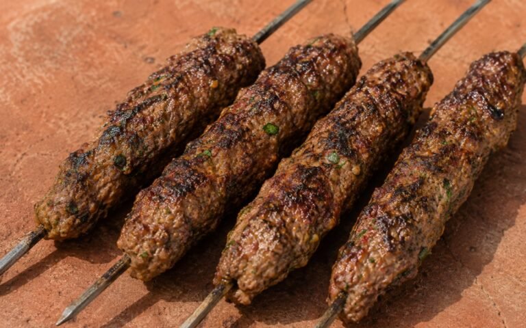 Simple beef kofta skewers with deep char served with fresh herbs